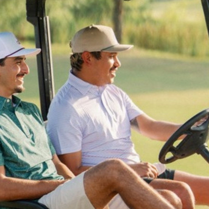 Jack Apparel golf hats - two golfers in a cart wearing Jack hats