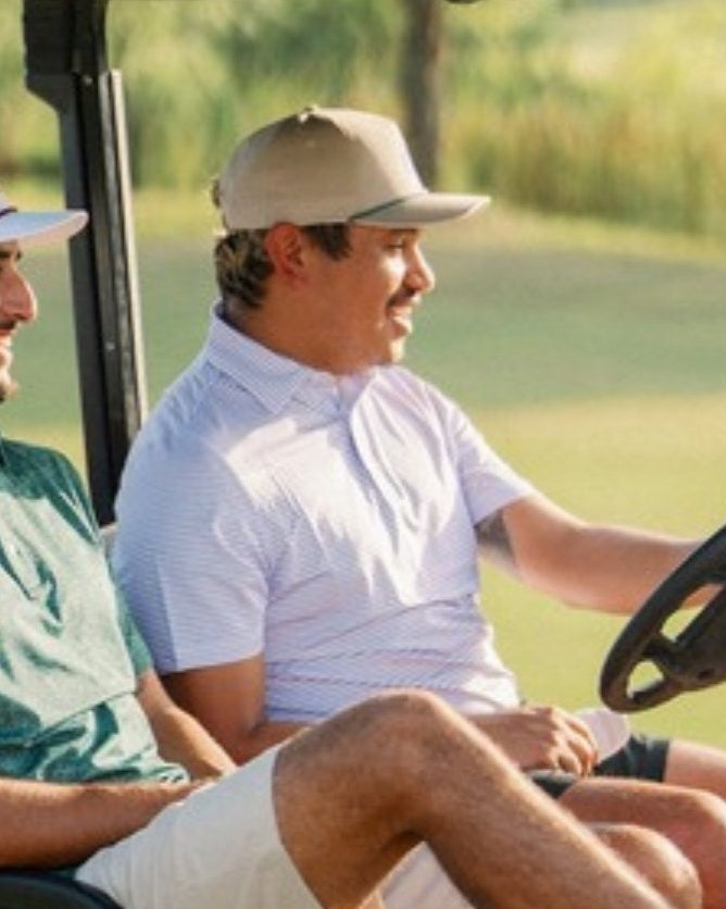 Jack Apparel golf hats - two golfers in a cart wearing Jack hats