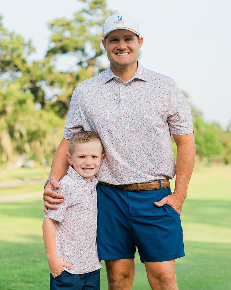 Father and son in matching HTX golf polos – Jack Apparel