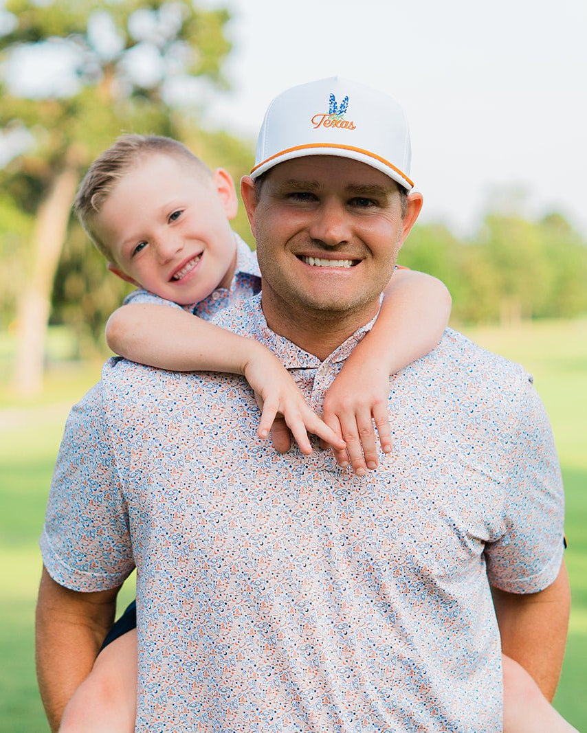 Father and son in matching HTX golf polos – Jack Apparel