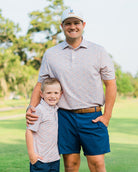 Father and son in matching HTX golf polos – Jack Apparel