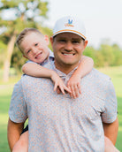 Father and son in matching HTX golf polos – Jack Apparel